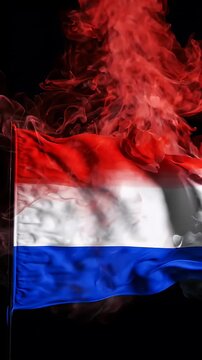 Red White Blue Smoke Flag Waves - Abstract red, white, and blue smoke forms the wavy shapes of a flag against a dark background.