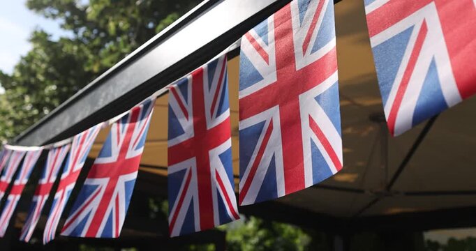 Details with the United Kingdom flags waving in the wind during a UK national celebration.