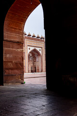 Fototapeta premium Framed Perspective Of Historic Mughal Courtyard And Grand Arched Entrance