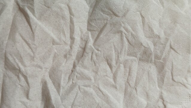 Close-up of crumpled white napkin fabric texture material for design background