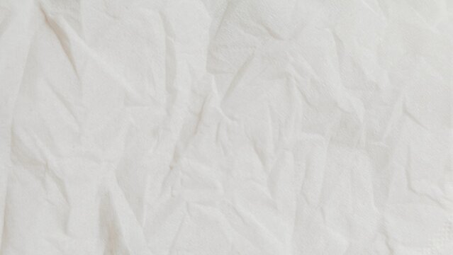 White crumpled paper texture background. Abstract wrinkled paper sheet backdrop.