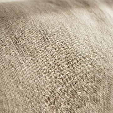 Close-up macro texture of beige woven linen.