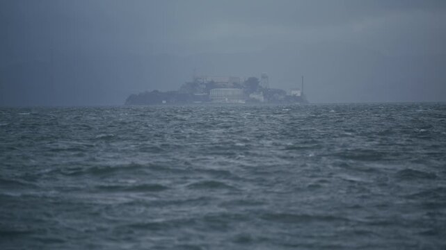 Old Alcatraz Island from Bay With Choppy Waves And Haze Of Storm