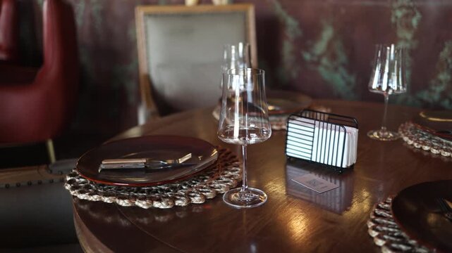 Beautifully Laid Table with Decorations in a Restaurant. Prepared for Visitors. Wine Glasses, Aperitif Plates. Cutlery Are Placed on the Table.