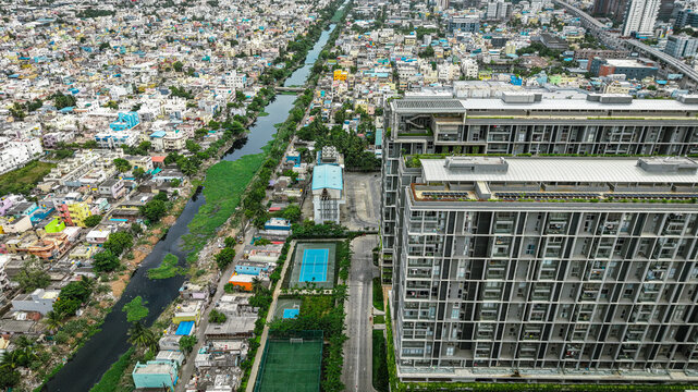 Aerial of densely populated residential area with blue pools and infrastructure
