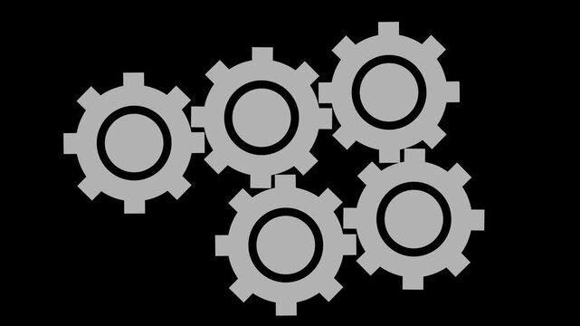 Five grey interlocking metal gears arranged in a cluster representing teamwork collaboration and mechanical engineering process on a dark background