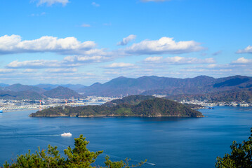 Obraz premium Elevated view of the Seto Inland Sea with a passing ferry and coastal mountains