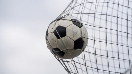 Naklejka premium The classic and emotional moment of a football match is a soccer ball that flew straight into the goal net. A photo with a place for the text.