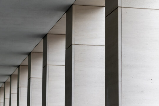 Abstract architectural background with a rhythmic perspective of modern concrete columns