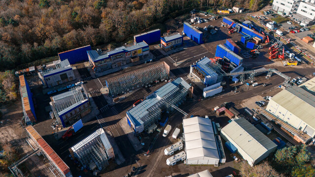 Slough, United Kingdom - 27 February 2026: Aerial view of Pinewood Studios featuring film set facades, scaffolding structures, and production equipment in the backlot area.
