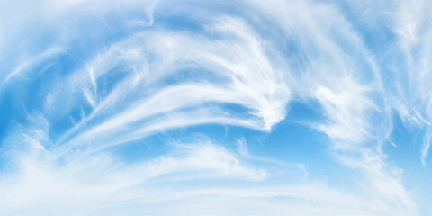 Wispy cirrus clouds drift across a vibrant blue sky, creating an ethereal and dreamlike atmosphere. © LumenCraft
