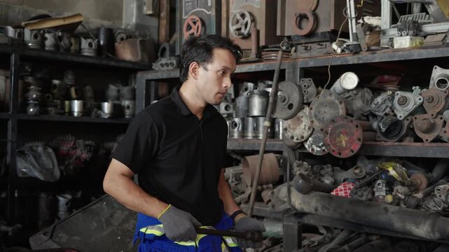 Portrait Of Confident Mechanic In Auto Parts Storage Room