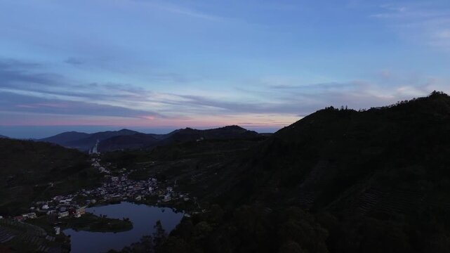 Aerial drone footage of the tranquil Telaga Cebong during dawn in the Dieng Plateau, Central Java, Indonesia. 