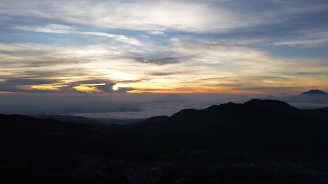 Aerial Drone View of Sunrise Between Mountain Ranges with Peaceful Morning Landscape