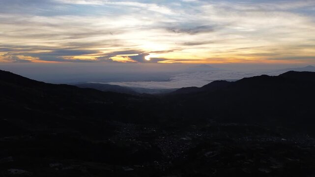 Aerial Drone View of Sunrise Between Mountain Ranges with Peaceful Morning Landscape