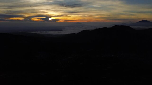 Aerial Drone View of Sunrise Between Mountain Ranges with Peaceful Morning Landscape