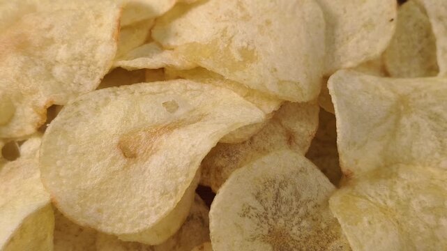 A pile of thin, crispy, golden potato chips