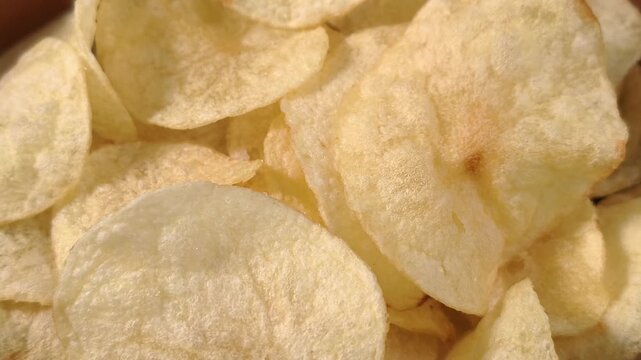 A pile of thin, crispy, golden potato chips