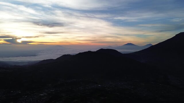 Aerial Drone View of Sunrise Between Mountain Ranges with Peaceful Morning Landscape
