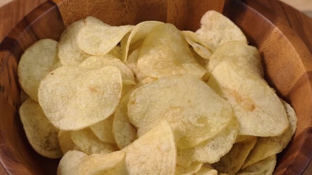A pile of thin, crispy, golden potato chips