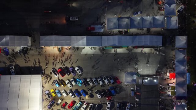 Aerial view of car display and tents at Batu Kawan Modifighter motorsport festival at night.