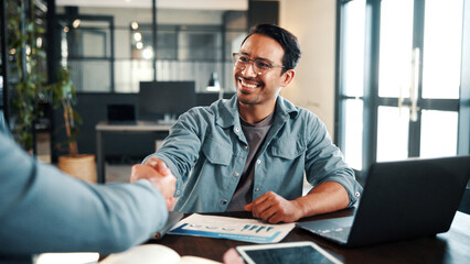 Obraz premium Handshake, meeting and business people with document for review, planning and graphs. Office, shaking hands and man with laptop for welcome, b2b budget and collaboration for proposal or negotiation