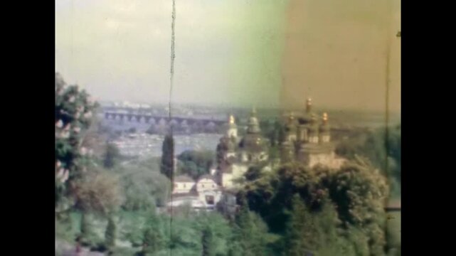Panoramic Kyiv view from botanical garden, historic st. Andrew church with golden domes in spring. Dnipro river with Paton bridge. Historic cityscape. Old film. Archival retro 1960s. Vintage archive