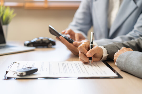 Business transport car and sell service concept, sales calculate sell price or rent of car for customer before sign on vehicle paperwork document contract with buyer woman client transfer automobile.
