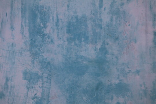 Blue wall gradually fading from weather exposure, retaining smooth texture and structural integrity throughout.