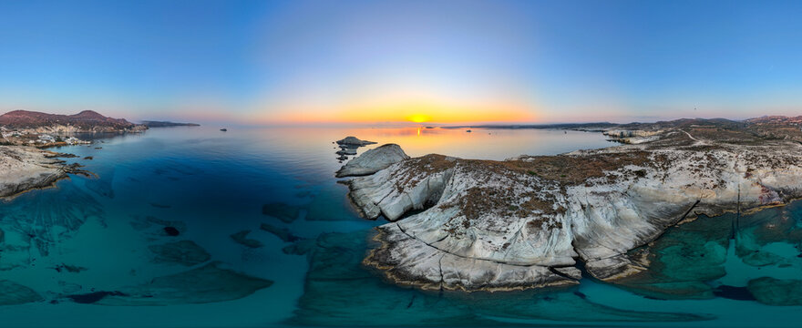 Panoramic, aerial view captured by drone of  the dramatic beach of Mandrakia  and Sarakiniko on the beautiful island of Milos in Greece during a summer sunrise in July. 