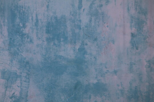 Blue wall gradually fading from weather exposure, retaining smooth texture and structural integrity throughout.
