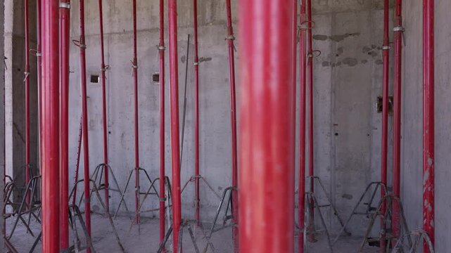 Temporary steel shoring props supporting concrete formwork