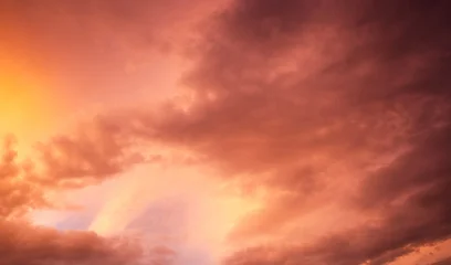 Fototapeten Coral Dramatic sunset over a dark landscape with fiery clouds, atmospheric sky view, moody natural scenery, intense color contrast, evening atmosphere  © ketrin