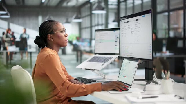 Quality Manager Reviewing Audit Reports On Laptop