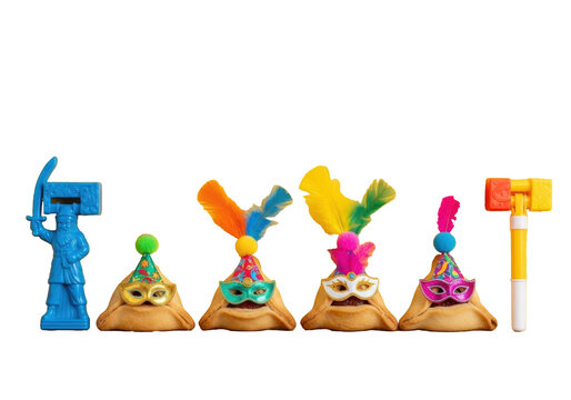 Five golden-brown Hamantaschen cookies, adorned with party hats & masks (teal, white, pink), and two plastic noisemakers on wood, yellow wall background, Purim holiday atmosphere