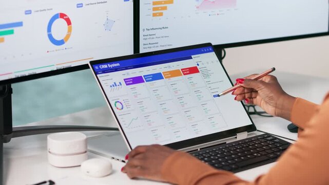 Young African American Woman Using CRM Software On Laptop