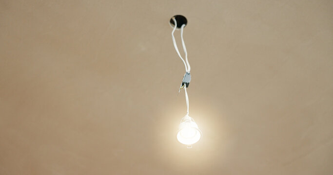Ceiling, wire and light in home for fitting, electrical compliance and incomplete infrastructure. Renovation, remodeling and lightbulb in house for circuit testing, installation and outlet with space