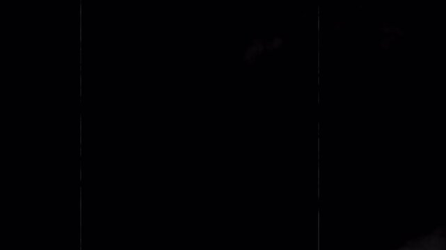 Noise, dirt, grain, dust and scratches on old damage film surface. Tv signal with bad interference, static noise background. Old film look on black background. 4K animation alpha channel