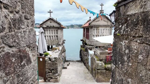 Picturesque alley with ancient horreo granaries facing the bay in Galicia