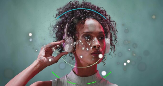 Turning model in ribbed top, white headphones adjusting cups in studio as ring appearing for demo
