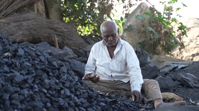 Indian senior man working at bricks factory