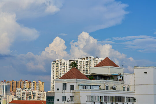 Scenery of city buildings under blue sky and white clouds