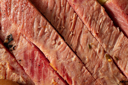 A closeup view of slices of Irish corned beef brisket, as a background.