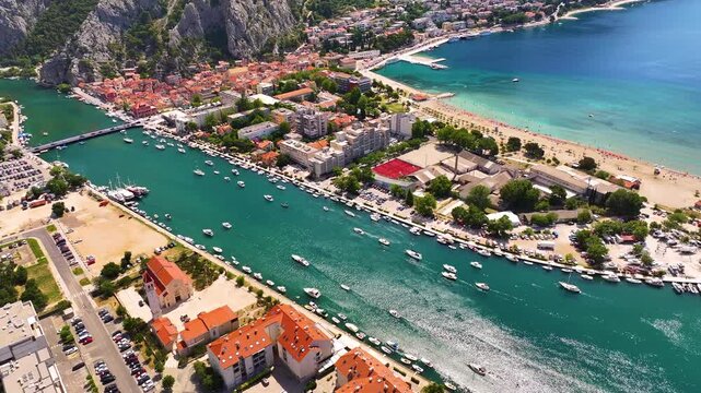 Aerial view of Omis Croatia with coastline, boats, and residential areas during daytime