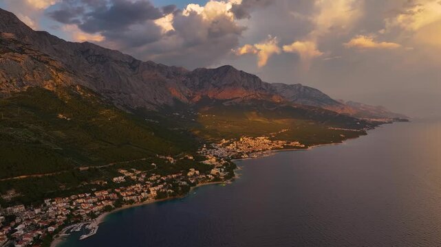 Brela Croatia coastline view with mountains and clouds during evening hours