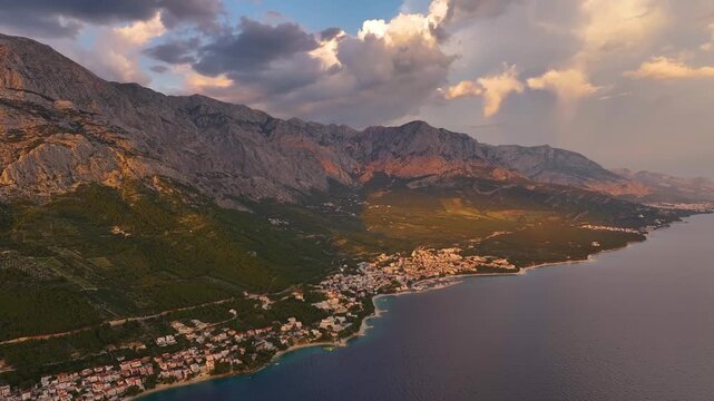 Brela Croatia aerial view showing coastline, mountains, and buildings during late afternoon