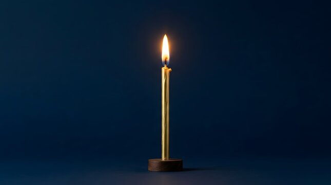 Single lit candle on dark blue background in minimalist style