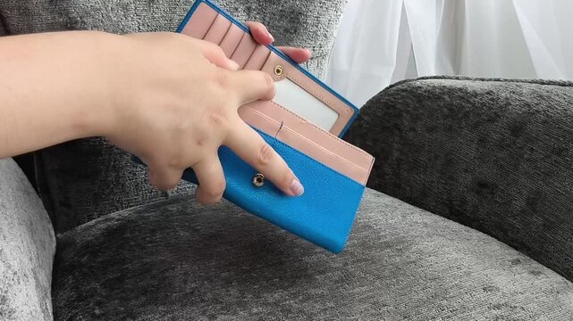 Woman shaking empty wallet, financial problems, lack of money, poverty, personal debt and economic crisis concept.