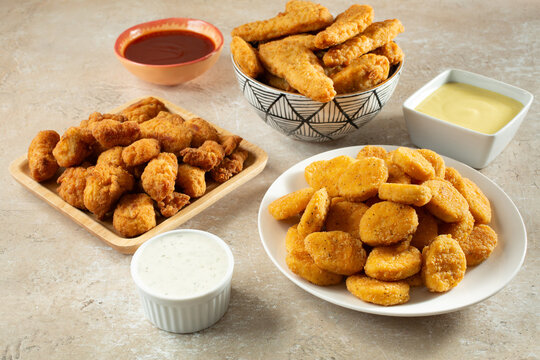 A view of a variety of gluten-free chicken nuggets and dairy-free dips.