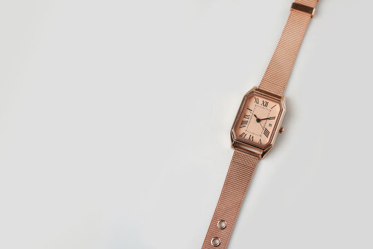 Elegant Rose Gold Rectangle watch with Mesh Strap isolated on White Background